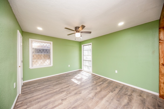 empty room featuring ceiling fan and light hardwood / wood-style floors