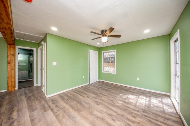 unfurnished room featuring hardwood / wood-style floors, a textured ceiling, and ceiling fan