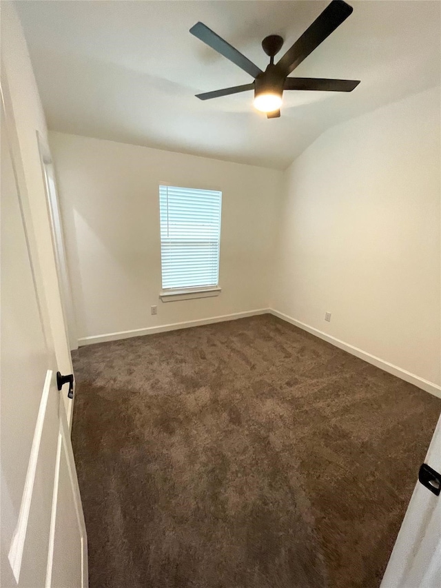 carpeted spare room featuring lofted ceiling and ceiling fan