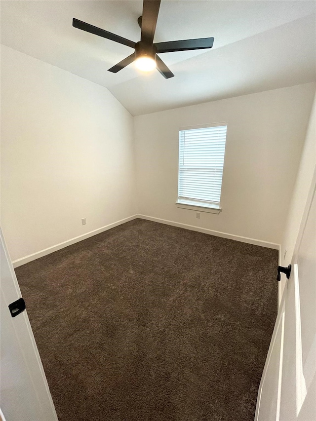 carpeted spare room with lofted ceiling and ceiling fan