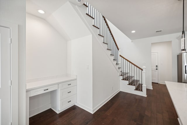 stairway featuring hardwood / wood-style floors and built in desk