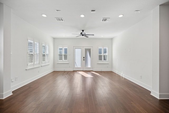 unfurnished living room with dark wood-type flooring, french doors, and ceiling fan