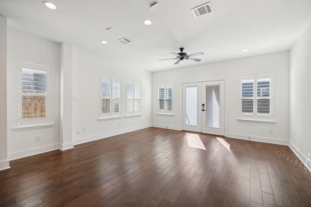 unfurnished living room with ceiling fan, dark wood-type flooring, and french doors