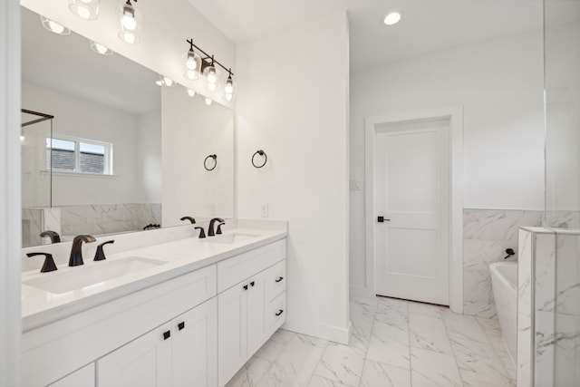 bathroom with a tub and vanity