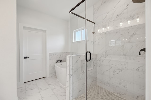 bathroom with tile walls and independent shower and bath