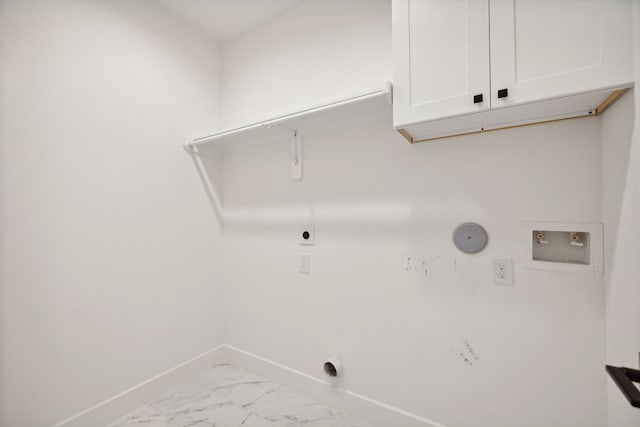 clothes washing area featuring hookup for a washing machine, cabinets, gas dryer hookup, and hookup for an electric dryer