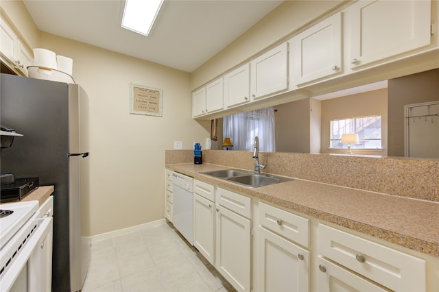 kitchen with sink, white cabinets, and white appliances