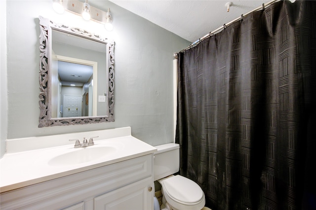 bathroom with vanity, a textured ceiling, toilet, and curtained shower