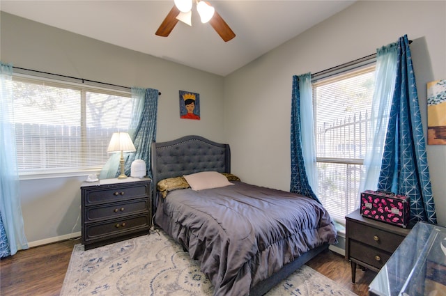 bedroom with hardwood / wood-style flooring, ceiling fan, and multiple windows