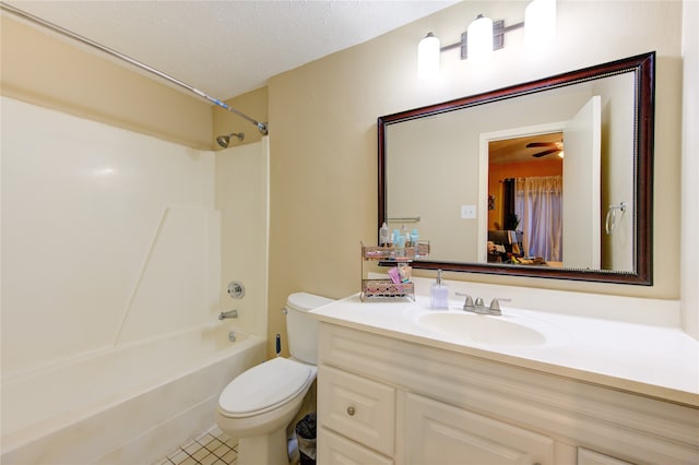 full bathroom with vanity, a textured ceiling, shower / washtub combination, ceiling fan, and toilet