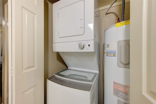 laundry room with stacked washer and dryer and water heater