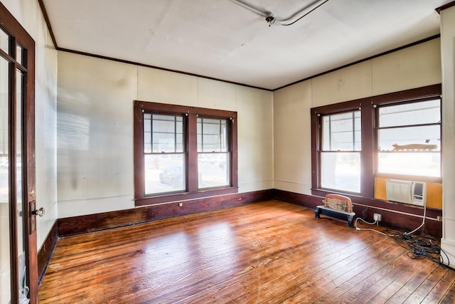 158 E Colorado, La Grange, TX 78945 - spare room featuring wood-type flooring, ornamental molding, and cooling unit