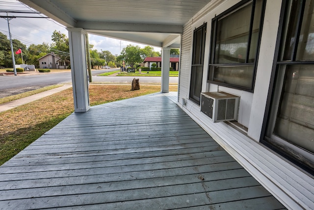 wooden deck featuring cooling unit