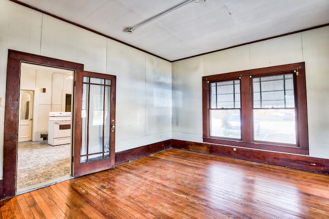 unfurnished room featuring ornamental molding and hardwood / wood-style floors