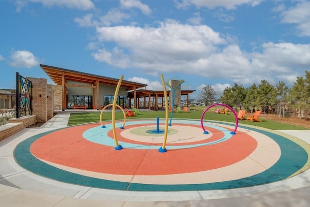 view of property's community featuring a playground and a yard