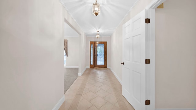 doorway featuring ornamental molding and light tile patterned floors