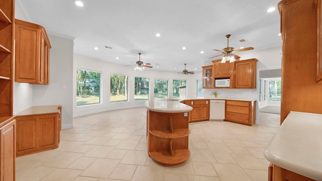 kitchen with plenty of natural light, kitchen peninsula, and white appliances