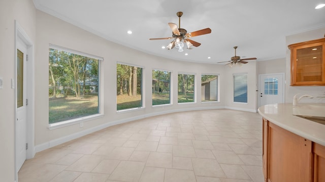 interior space with ceiling fan and sink