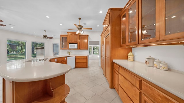 kitchen featuring a wealth of natural light, white appliances, and a center island