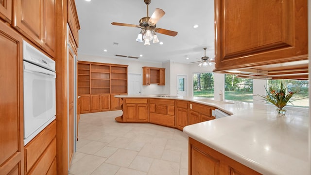 kitchen with ceiling fan, ornamental molding, kitchen peninsula, and white appliances