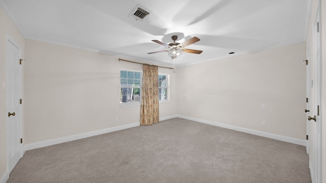 carpeted empty room featuring ornamental molding and ceiling fan