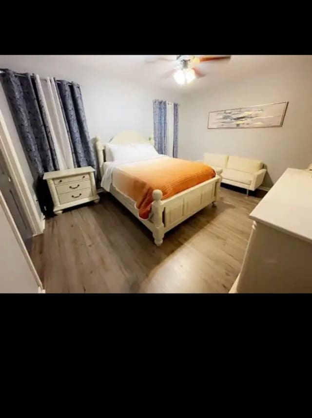 bedroom featuring ceiling fan and dark hardwood / wood-style flooring