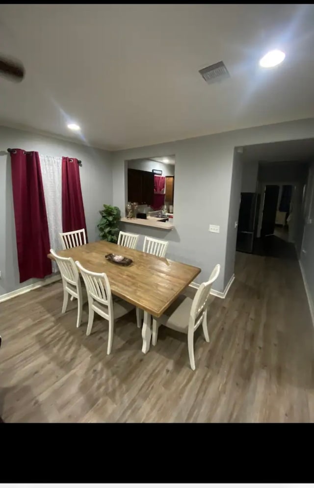 dining space with light hardwood / wood-style floors