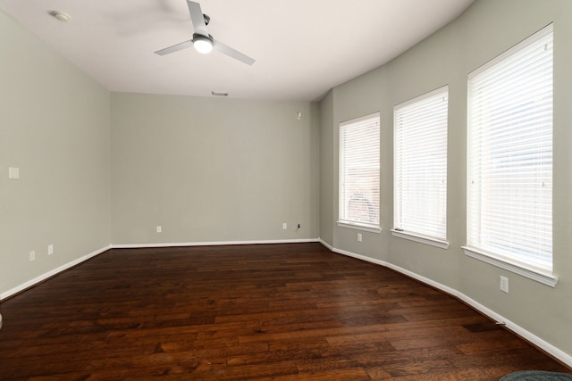 unfurnished room featuring ceiling fan and dark wood-type flooring