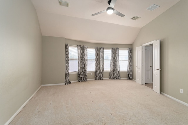 carpeted spare room with lofted ceiling and ceiling fan