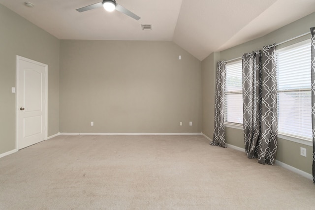 carpeted empty room with ceiling fan and vaulted ceiling