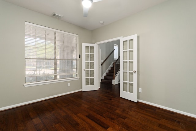 unfurnished room with ceiling fan, dark wood-type flooring, and french doors