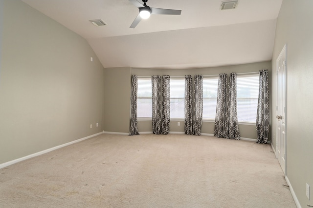 carpeted empty room with ceiling fan and vaulted ceiling