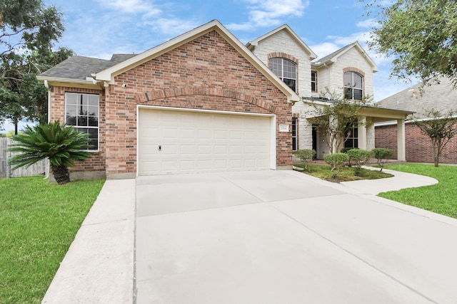 view of front of property with a garage and a front lawn