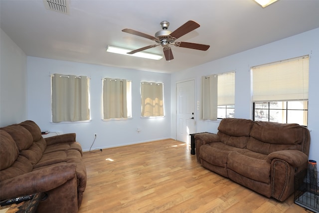 living room with ceiling fan and light hardwood / wood-style floors