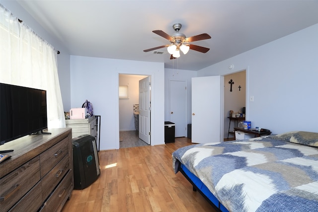 bedroom featuring ceiling fan, connected bathroom, and light hardwood / wood-style flooring