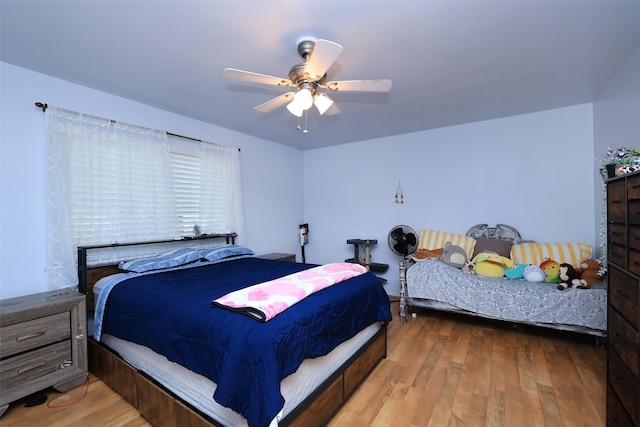 bedroom with hardwood / wood-style flooring and ceiling fan