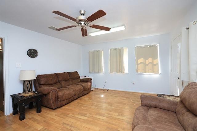 living room featuring light wood-type flooring and ceiling fan