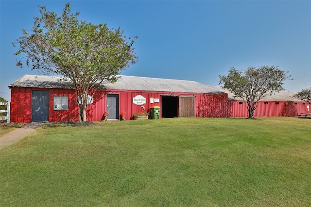 exterior space featuring a lawn and an outbuilding