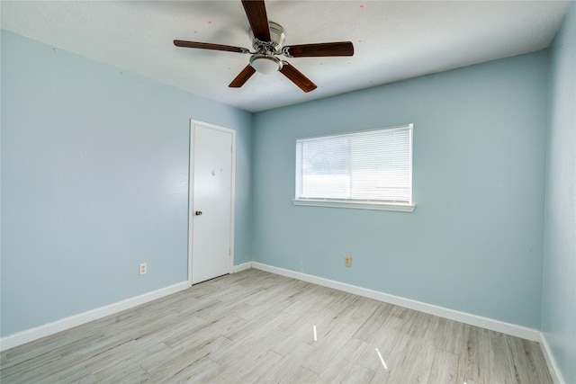 unfurnished room with light wood-type flooring and ceiling fan