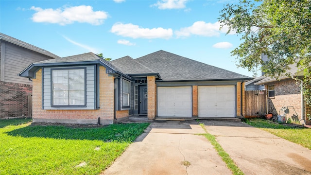 ranch-style home featuring a garage and a front lawn