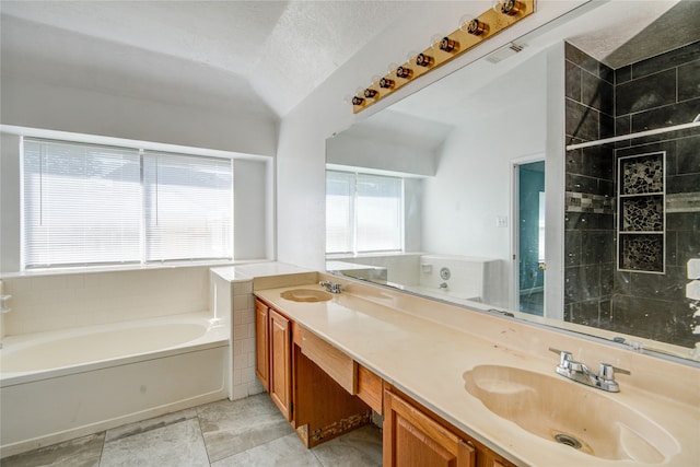 bathroom with vanity, lofted ceiling, and plenty of natural light