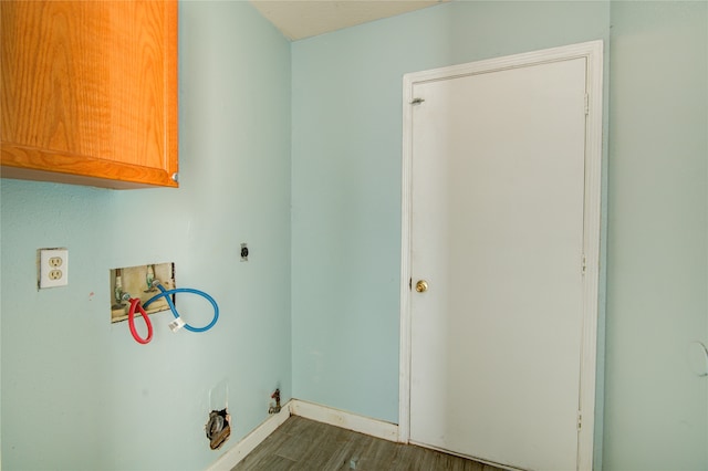 laundry room with hookup for a washing machine, cabinets, dark hardwood / wood-style floors, and hookup for an electric dryer