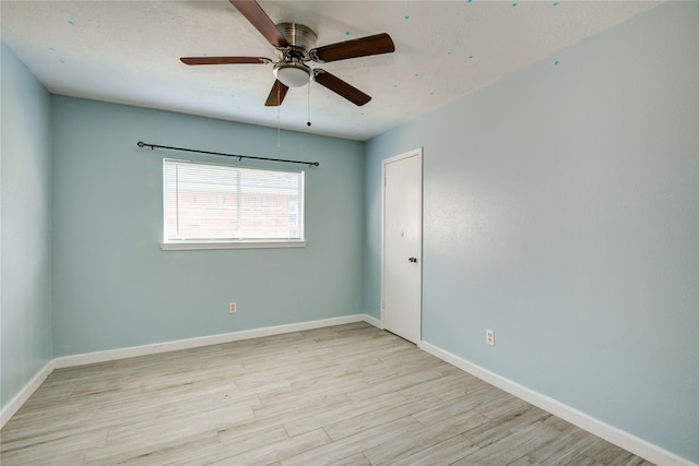 empty room featuring ceiling fan and light hardwood / wood-style flooring