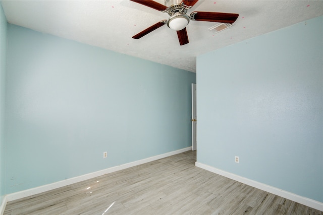 spare room with light wood-type flooring and ceiling fan