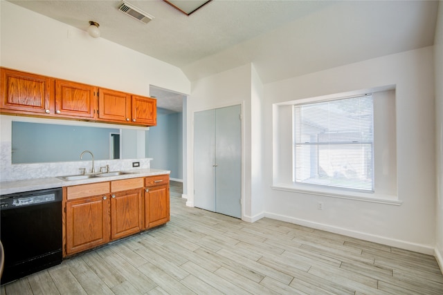 kitchen with dishwasher, light hardwood / wood-style flooring, vaulted ceiling, and sink