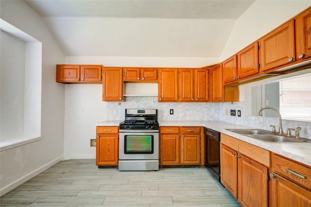 kitchen featuring lofted ceiling, sink, stainless steel range with gas stovetop, dishwasher, and decorative backsplash