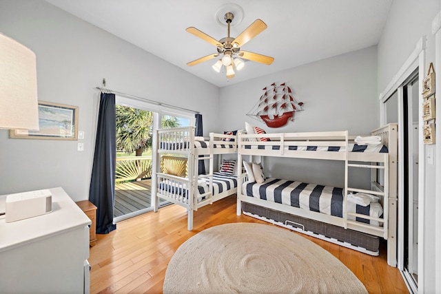 bedroom with ceiling fan, hardwood / wood-style floors, and access to outside