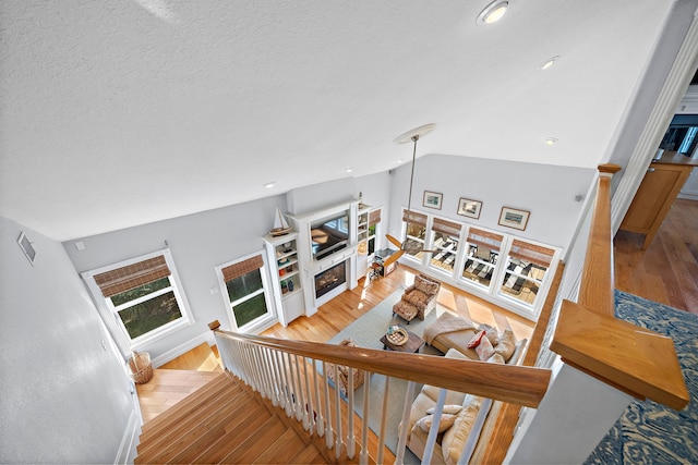 living room featuring light wood-type flooring and vaulted ceiling