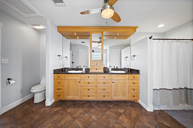 bathroom with ceiling fan, vanity, and toilet