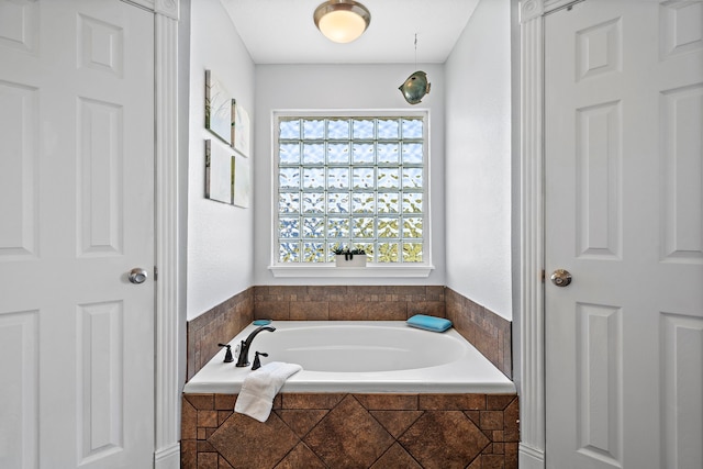 bathroom featuring tiled bath